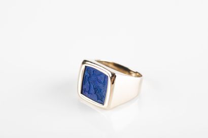 Gold signet ring holding a lapis lazuli intaglio...