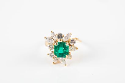 Yellow gold floral ring set with a cut emerald...