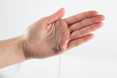 Figaro chain in platinum holding a yellow...