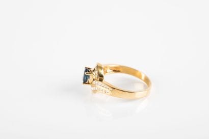Yellow gold ring centered on an oval sapphire...