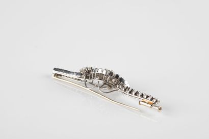 A white gold and platinum brooch with a moving...