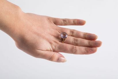 Yellow gold ring holding a round-cut rose...