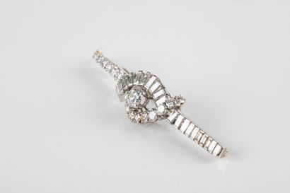 A white gold and platinum brooch with a moving...