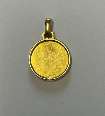Round medal decorated with a cross in relief...