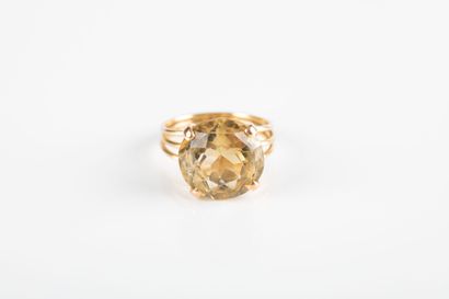 Yellow gold ring holding a round-cut citrine...