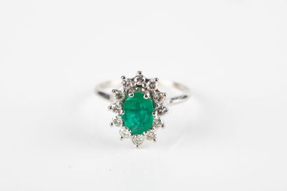 White gold daisy ring set with an oval emerald...
