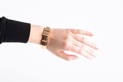 Rigid gold bracelet decorated with geometric...