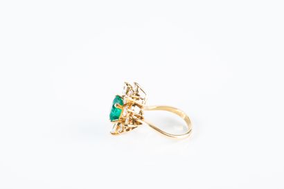 Yellow gold floral ring set with a cut emerald...