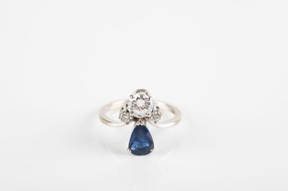 White gold ring set with a pear-cut sapphire...