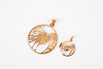 Lot including two circular pendants in yellow...