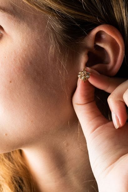 Pair of sleeper earrings featuring a flower...