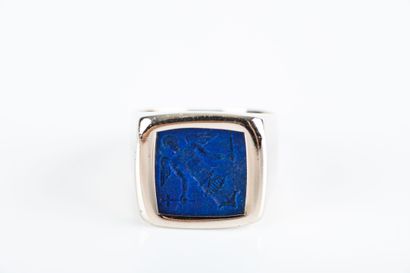 Gold signet ring holding a lapis lazuli intaglio...