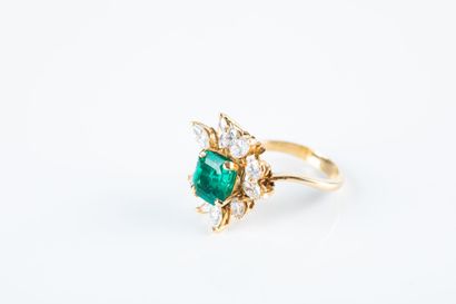 Yellow gold floral ring set with a cut emerald...