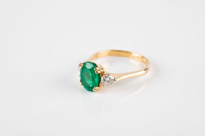 Yellow gold ring set with an oval emerald...