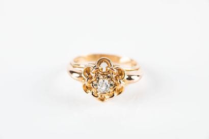 Yellow gold daisy ring centered with a colorless...