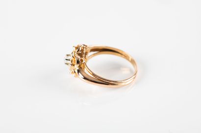 Yellow gold daisy ring centered with a colorless...