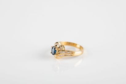 Yellow gold ring centered on an oval sapphire...