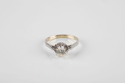 Gold and platinum solitaire ring set with...