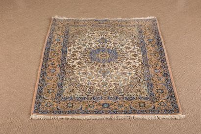 Iranian wool and silk carpet with rich floral...