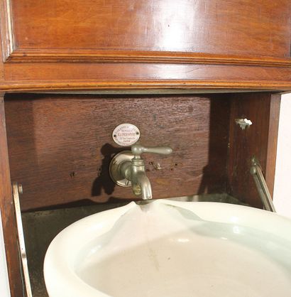 Cabin sink in blond mahogany. Zinc water...