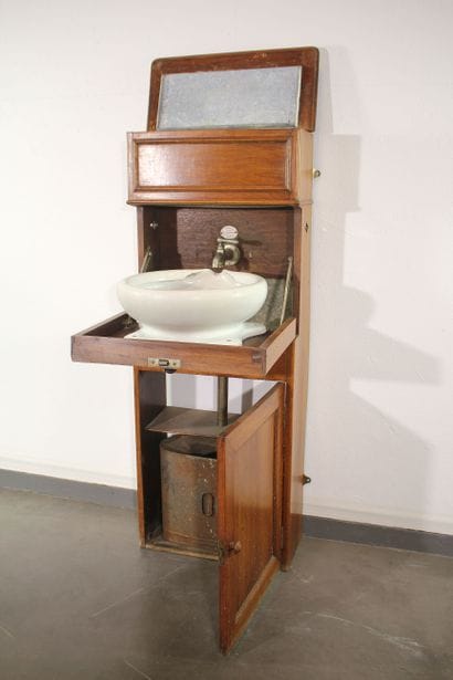 Cabin sink in blond mahogany. Zinc water...
