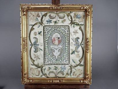 Embroidery on silk surrounding a canivet...