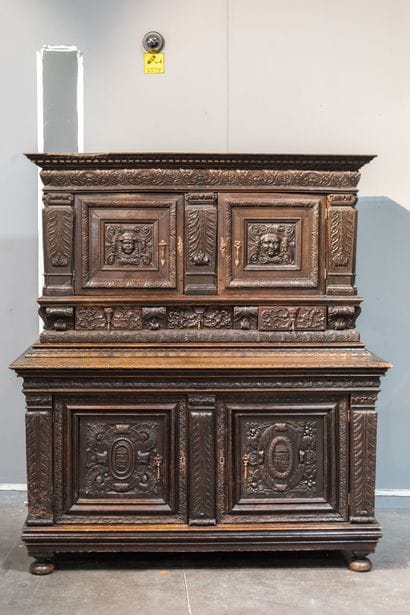 Two-part sideboard in molded and carved oak....