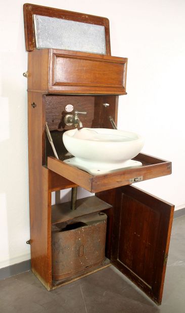 Cabin sink in blond mahogany. Zinc water...