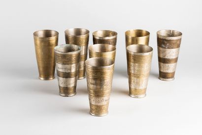 Nine steel lassi cups, turned and hammered...