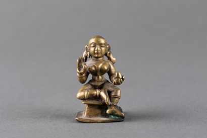 Female divinity seated on a pedestal. Patinated...