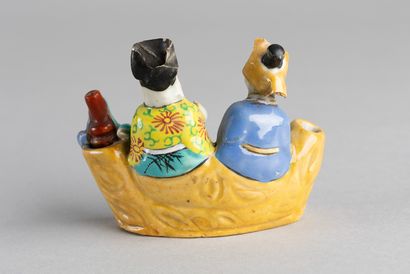 Group of two figures, one with a large white...