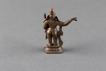 Male divinity standing on a pedestal. Patinated...