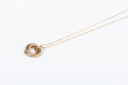 Yellow gold forcat chain holding a pendant...