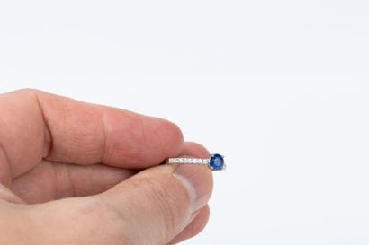 White gold ring set with a blue sapphire...