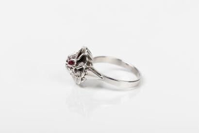White gold ring depicting a flower with striated...