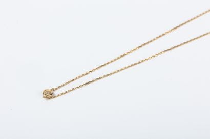 Yellow gold forcat link necklace holding...
