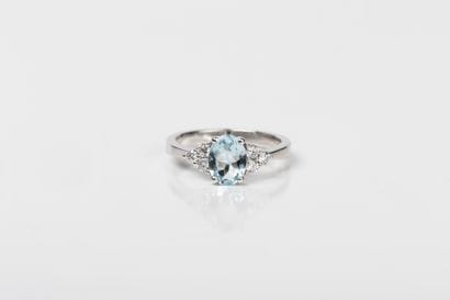 White gold ring adorned with an oval aquamarine...