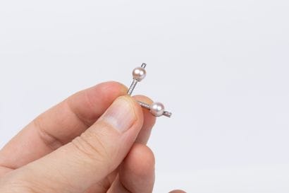 Pair of white gold barette earrings set with...