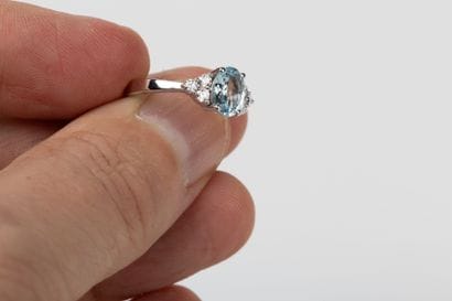 White gold ring adorned with an oval aquamarine...