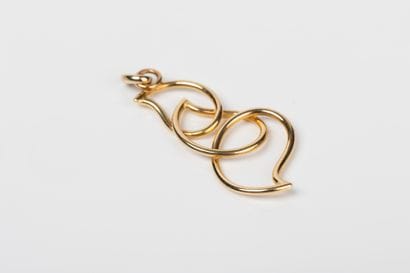 Yellow gold pendant represented by three...