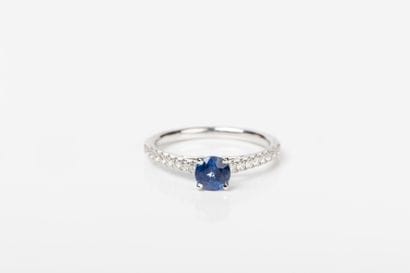 White gold ring set with a blue sapphire...