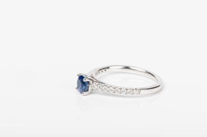 White gold ring set with a blue sapphire...