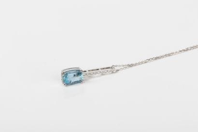 White gold chain holding a baguette pendant...
