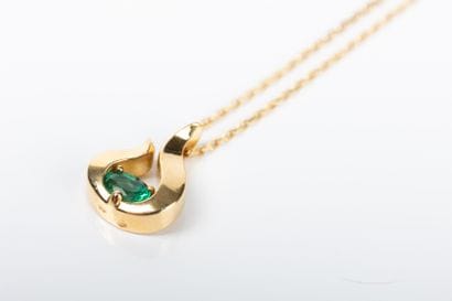 Yellow gold chain holding a pendant with...
