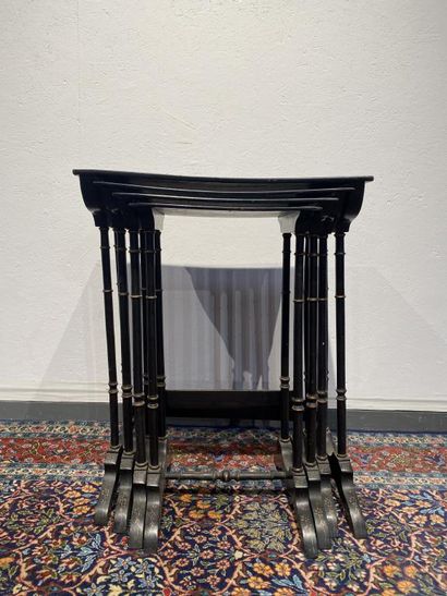 Set of four nesting tables in black lacquered...