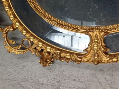 Oval wood and gilded stucco mirror with shell...