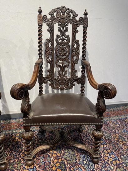 Pair of walnut armchairs, richly carved with...