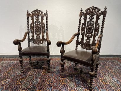 Pair of walnut armchairs, richly carved with...