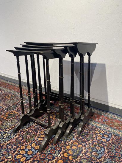 Set of four nesting tables in black lacquered...
