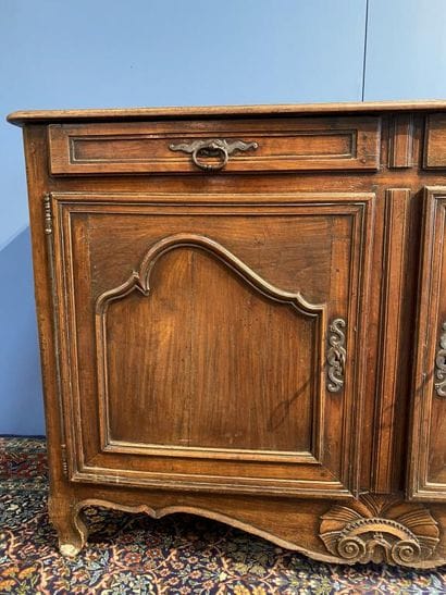 Moulded natural wood sideboard opening to...